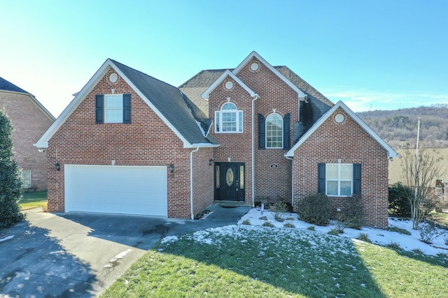 view of property with a front lawn and a garage