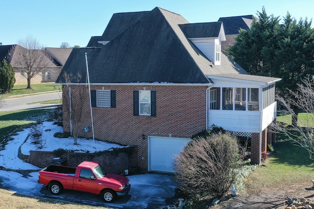 exterior space featuring a garage and a sunroom