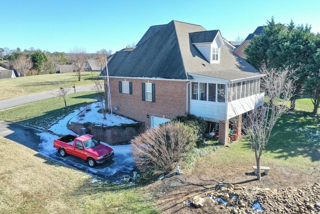 view of property exterior featuring a sunroom and a yard