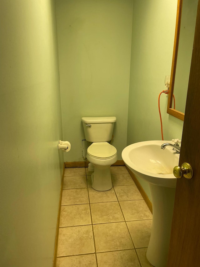 bathroom featuring tile patterned flooring and toilet