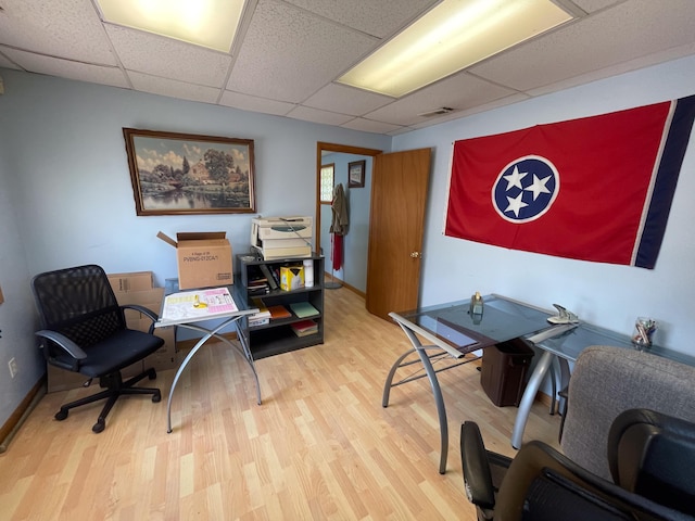 office featuring wood-type flooring and a paneled ceiling