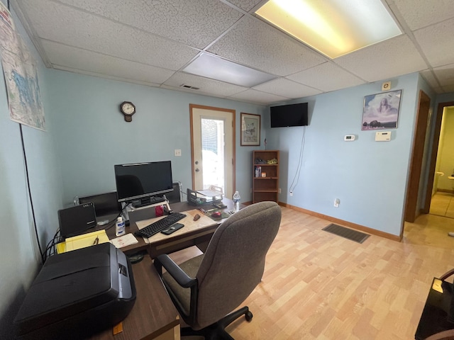 office space featuring a drop ceiling and light hardwood / wood-style floors