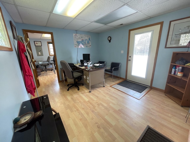 office space featuring a drop ceiling and light hardwood / wood-style floors