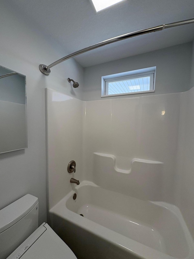 full bathroom featuring tub / shower combination and toilet