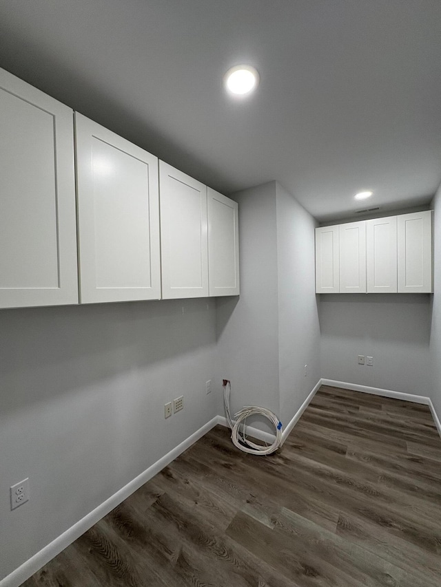 laundry area featuring recessed lighting, visible vents, dark wood finished floors, and baseboards