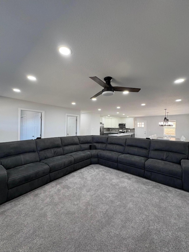 unfurnished living room featuring a textured ceiling, carpet floors, a ceiling fan, and recessed lighting