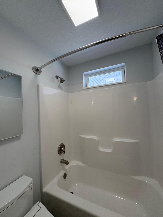 full bathroom featuring toilet and shower / bathtub combination