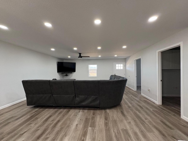 living area with ceiling fan, baseboards, wood finished floors, and recessed lighting