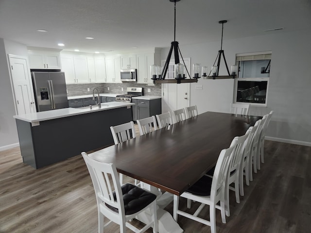 dining area with dark wood-style floors, baseboards, and recessed lighting