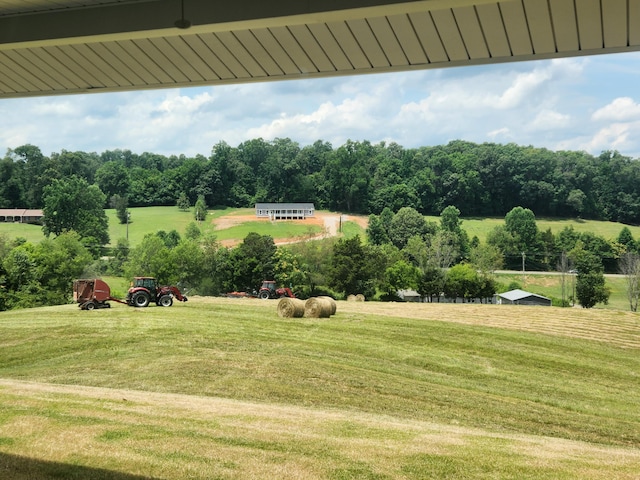 exterior space featuring a rural view and a yard