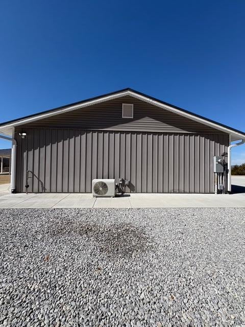 view of home's exterior featuring board and batten siding and ac unit