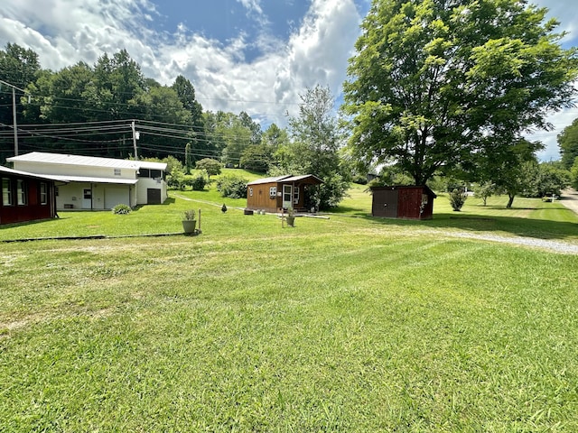 4140 Chavis Rd, Cosby, TN 37722 - view of green lawn featuring a shed and an attached garage