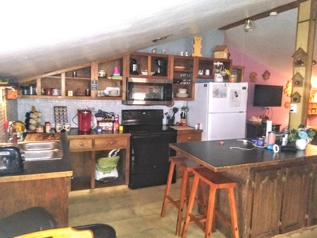 kitchen with lofted ceiling, a kitchen breakfast bar, sink, black electric range, and white fridge