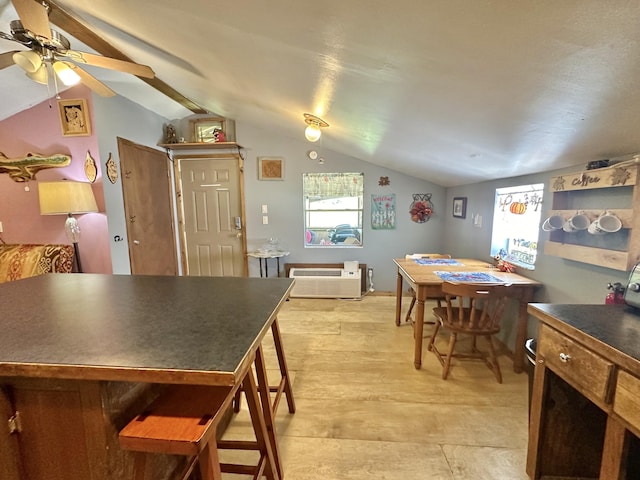 4140 Chavis Rd, Cosby, TN 37722 - dining area featuring lofted ceiling, ceiling fan, light wood-style flooring, and a wall mounted air conditioner