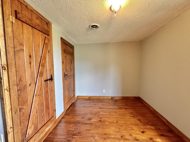 4140 Chavis Rd, Cosby, TN 37722 - unfurnished bedroom with hardwood / wood-style flooring and a textured ceiling