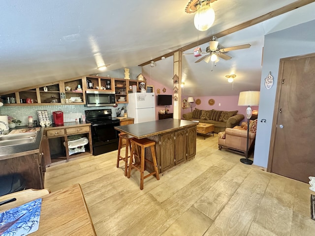 4140 Chavis Rd, Cosby, TN 37722 - kitchen featuring black electric range, stainless steel microwave, freestanding refrigerator, vaulted ceiling, and ceiling fan