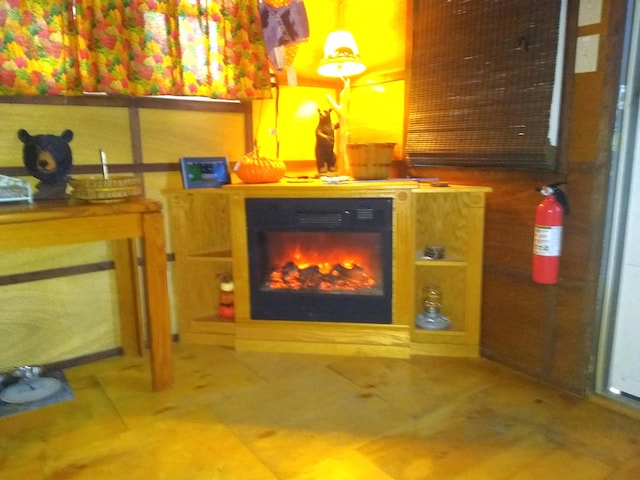 unfurnished room featuring tile patterned flooring and a fireplace