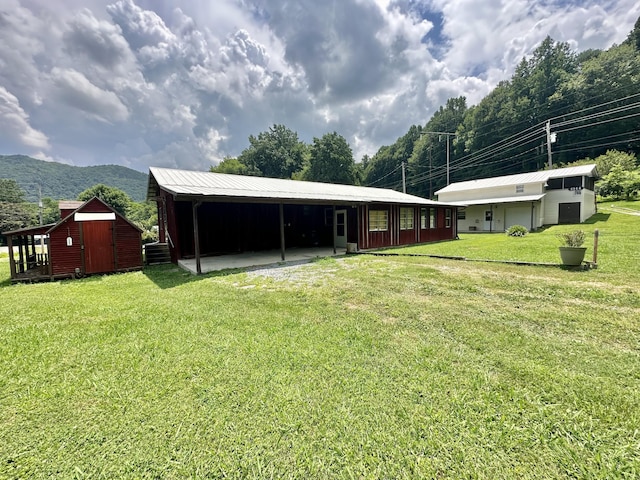 4140 Chavis Rd, Cosby, TN 37722 - view of grassy yard featuring an outbuilding, a mountain view, and a carport