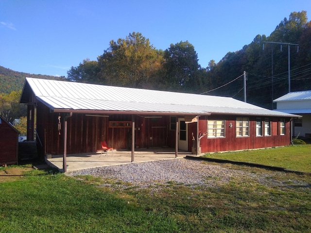 back of property featuring a yard and a patio