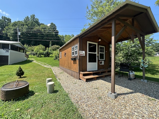 4140 Chavis Rd, Cosby, TN 37722 - view of property exterior with an outdoor fire pit, a yard, and an outbuilding