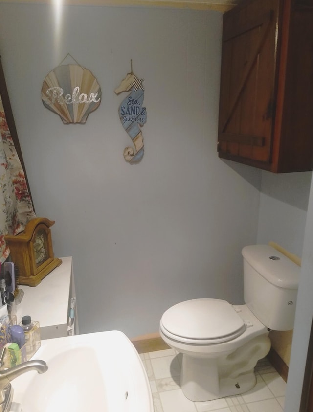 bathroom featuring tile patterned floors, toilet, and sink