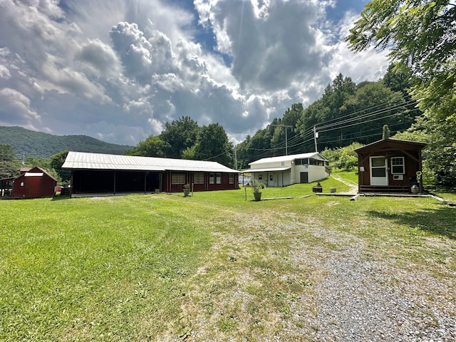 4140 Chavis Rd, Cosby, TN 37722 - view of green lawn with an outdoor structure and a mountain view