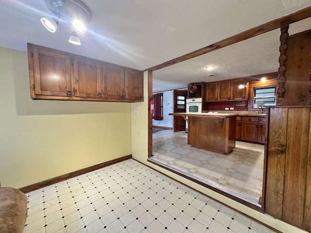 4140 Chavis Rd, Cosby, TN 37722 - kitchen with light flooring, oven, healthy amount of natural light, and brown cabinets