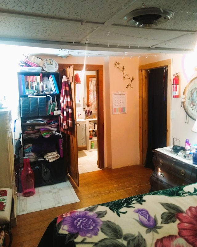 bedroom featuring ensuite bathroom and light hardwood / wood-style flooring