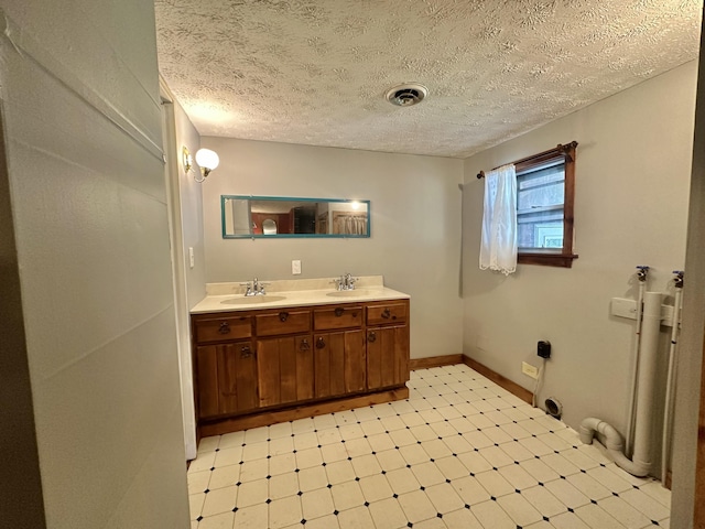 4140 Chavis Rd, Cosby, TN 37722 - full bathroom featuring tile patterned floors, double vanity, and a textured ceiling