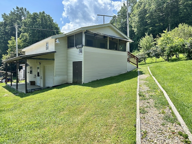 4140 Chavis Rd, Cosby, TN 37722 - view of side of property featuring a yard, a garage, and a patio area