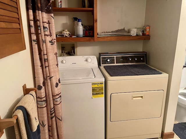 clothes washing area featuring separate washer and dryer