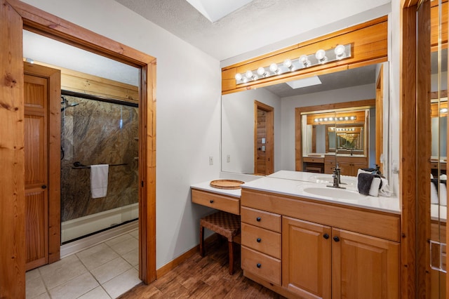 449 Lucerne Way, Gatlinburg, TN 37738 - full bathroom with vanity, baseboards, a skylight, a shower stall, and a textured ceiling