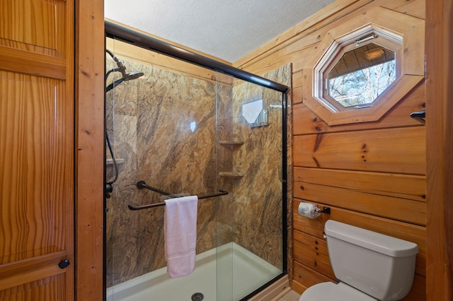 449 Lucerne Way, Gatlinburg, TN 37738 - full bathroom with wooden walls, toilet, a shower stall, and a textured ceiling