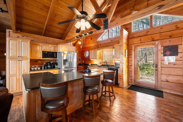 449 Lucerne Way, Gatlinburg, TN 37738 - kitchen featuring wooden walls, black microwave, stainless steel fridge with ice dispenser, beamed ceiling, and dishwasher