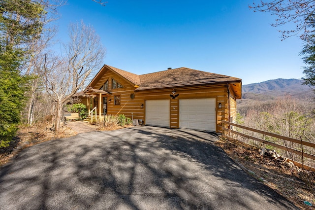 449 Lucerne Way, Gatlinburg, TN 37738 - view of side of property with fence, aphalt driveway, roof with shingles, a garage, and a mountain view