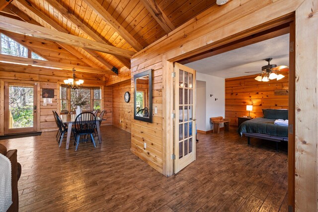 449 Lucerne Way, Gatlinburg, TN 37738 - dining space with lofted ceiling with beams, dark wood finished floors, an inviting chandelier, wood walls, and wood ceiling
