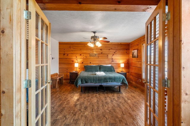 449 Lucerne Way, Gatlinburg, TN 37738 - bedroom featuring french doors, wood finished floors, wood walls, and a textured ceiling
