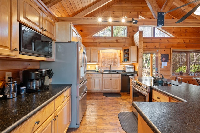 449 Lucerne Way, Gatlinburg, TN 37738 - kitchen featuring beamed ceiling, light wood-style floors, wooden walls, appliances with stainless steel finishes, and wood ceiling