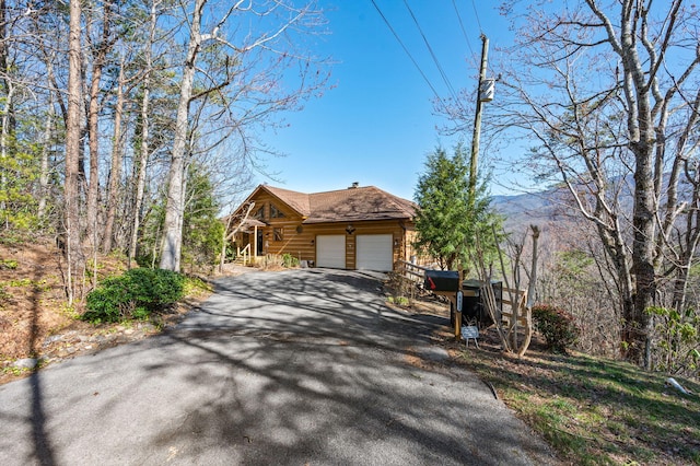 449 Lucerne Way, Gatlinburg, TN 37738 - view of front of property featuring aphalt driveway, a chimney, a garage, and log siding