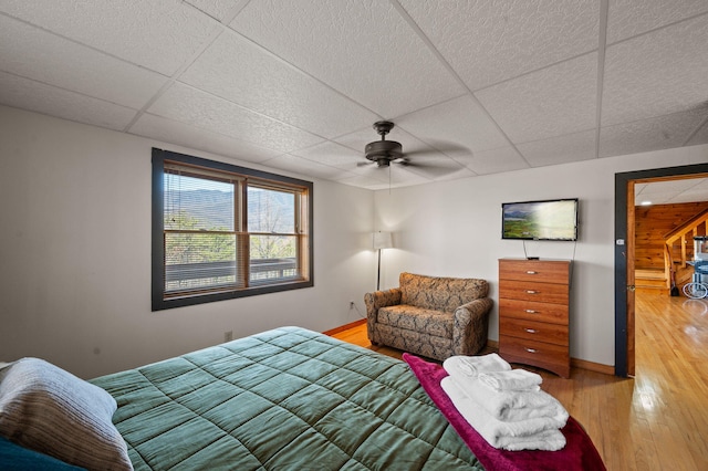 449 Lucerne Way, Gatlinburg, TN 37738 - bedroom with baseboards, a paneled ceiling, ceiling fan, and light wood finished floors