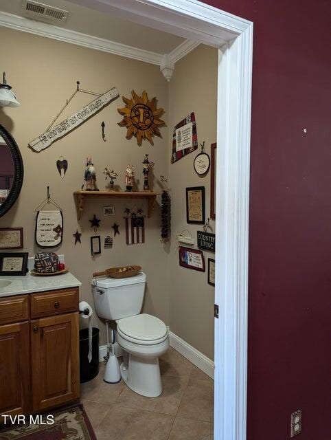 bathroom featuring tile patterned floors, vanity, toilet, and ornamental molding