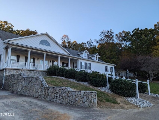 farmhouse inspired home featuring covered porch