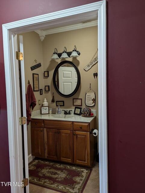 bathroom featuring vanity and ornamental molding