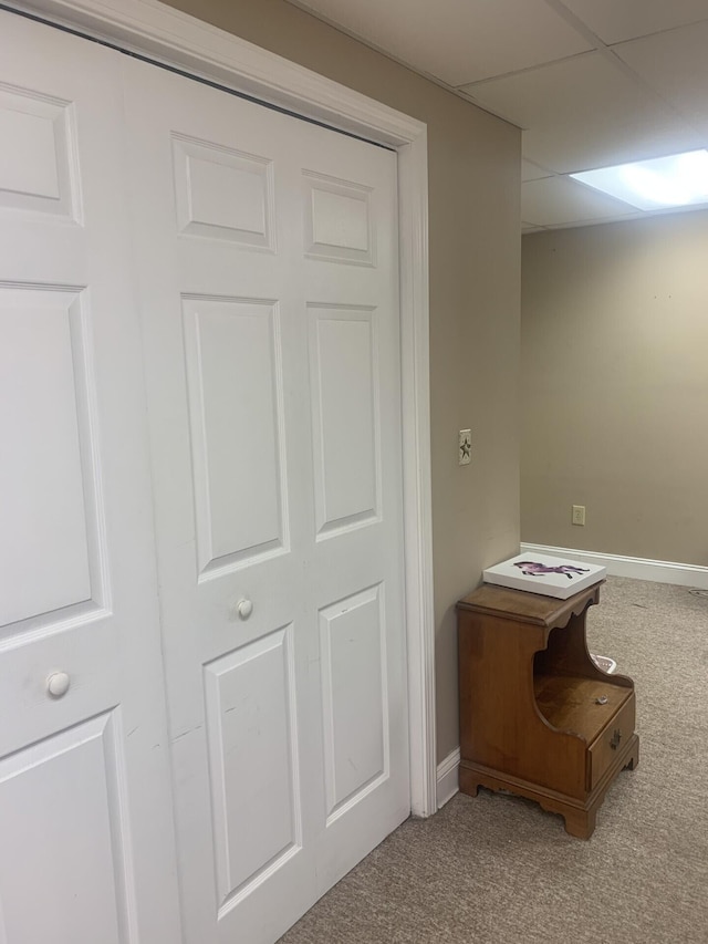 interior space featuring a drop ceiling and carpet