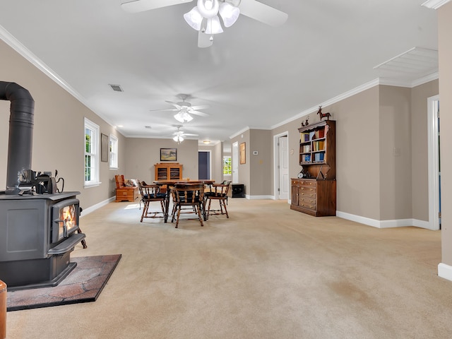 6525 Idumea Rd, Corryton, TN 37721 - dining area with a wood stove, ceiling fan, baseboards, and ornamental molding