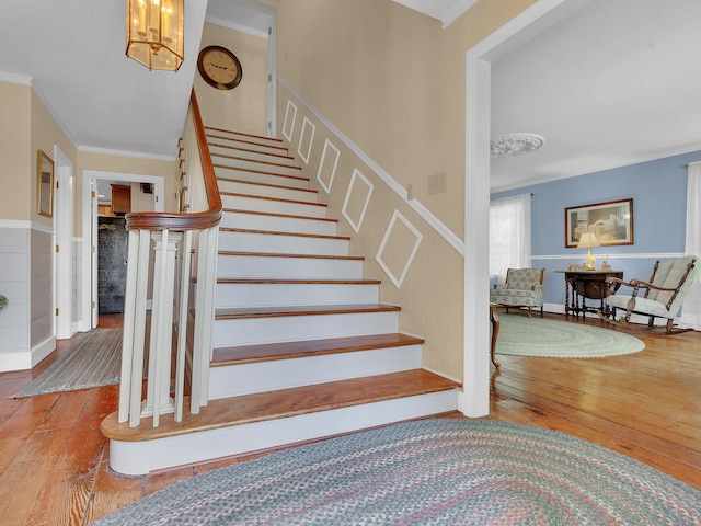 6525 Idumea Rd, Corryton, TN 37721 - stairway featuring wood-type flooring, crown molding, and a wainscoted wall