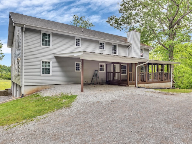 6525 Idumea Rd, Corryton, TN 37721 - back of property featuring a sunroom, a chimney, and gravel driveway