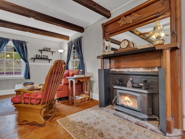 6525 Idumea Rd, Corryton, TN 37721 - sitting room with wood finished floors, a wood stove, beamed ceiling, and a wainscoted wall