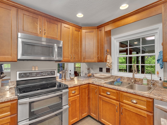 6525 Idumea Rd, Corryton, TN 37721 - kitchen featuring appliances with stainless steel finishes, a sink, light countertops, brown cabinetry, and recessed lighting