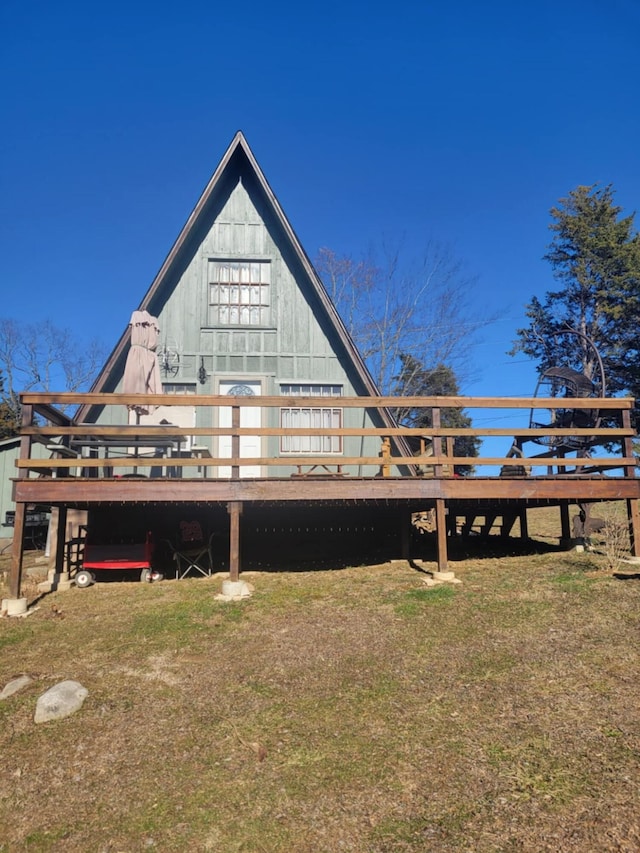 rear view of house with a lawn and a deck